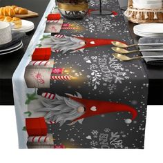 a christmas table runner with santa clause and candy canes on it, along with other festive items