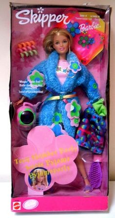 the barbie doll is wearing a bright blue coat and pink dress with flowers on it