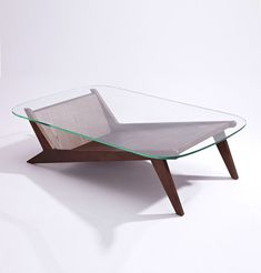 a glass and wood coffee table with a wooden frame on it's legs, in front of a white background