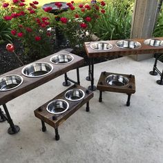 four elevated dog bowls and two benches made out of wood