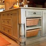 a kitchen island with two baskets on it's sides and an oven in the background