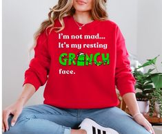 Funny Resting Grinch Face Merry Christmas Sweater. Perfect as a gift or for special occasions, ugly sweater parties, holidays and more! These garments are made from polyester and cotton. The collar is ribbed knit, so it retains its shape even after washing. There are no itchy side seams on these sweaters.  .: Made with a medium-heavy fabric blend of 50% cotton and 50% polyester (8.0 oz/yd² (271.25 g/m this sweatshirt feels cozy and is the perfect choice for those colder months. .: The classic fit along with the crew neckline deliver a comfy wearing experience with a clean-cut style. Meanwhile, the double-needle stitching at the shoulder, armhole, neck, waistband, and cuff seams add top-tier durability.  .: Say goodbye to itchiness thanks to the gray, pearlized tear-away label.  .: Made usi Grinch Face Sweater, Resting Grinch Face, Funny Christmas Sweater, Grinch Face, Funny Christmas Sweaters, Ugly Sweater Party, Sweater Christmas, Christmas 2024, Funny Christmas