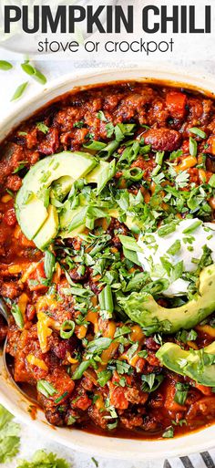 a white bowl filled with chili and avocado