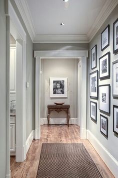 an empty hallway with pictures on the wall