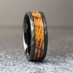 a wooden ring with black and brown wood inlays on the inside of it