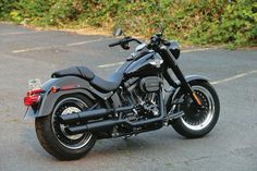 a black motorcycle is parked on the street