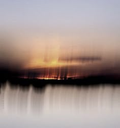 the sky is reflected in the water as it looks like clouds are coming up from the horizon