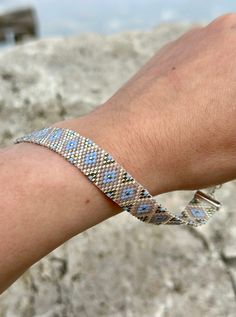 a person's arm with a bracelet on it