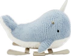 a blue stuffed whale sitting on top of a wooden sled