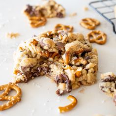 cookies and pretzels are on the counter with one half eaten cookie in the foreground