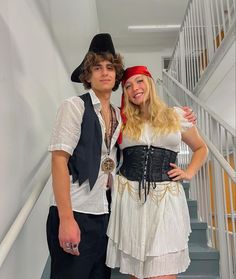 a man and woman dressed in pirate costumes