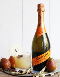 a bottle of wine sitting next to some apples and an apple slice on a plate