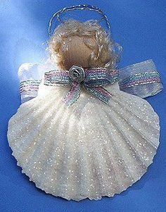 an angel ornament is shown on a blue background with white sequins