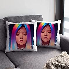 two pillows on a couch with a woman's face in the background and rainbow hair