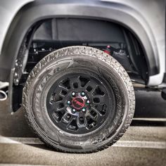 the front wheel and tire of a silver truck