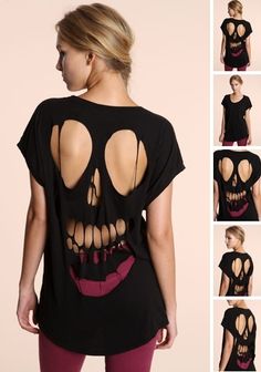 the back of a woman's black shirt with cutouts and a skull on it