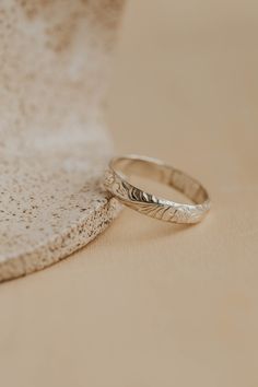 two wedding rings sitting on top of a table