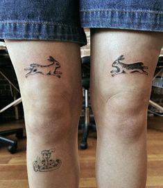 two small tattoos on the legs of people with dogs and motorcycle symbols tattooed on them