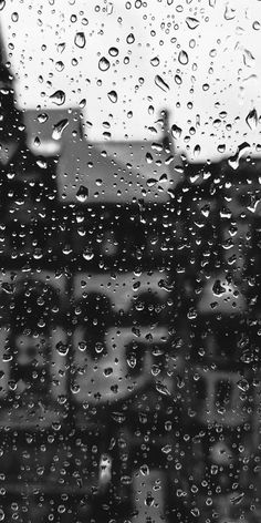 black and white photo of rain drops on window