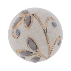 a white ball with gold leaf designs on it