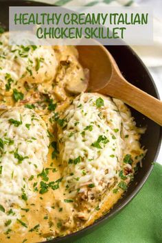 a skillet filled with chicken and cheese covered in sauce