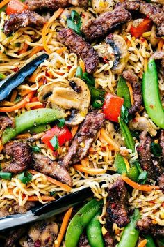 stir fried noodles with meat and vegetables in a skillet, ready to be eaten