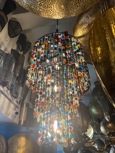 a chandelier hanging from the ceiling in a room with other items on it