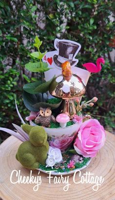 a close up of a plate with flowers and other things on it that says cheeky fairy cottage