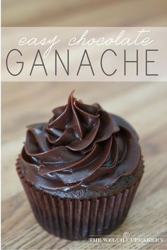 a chocolate cupcake on a wooden table with the words easy chocolate ganache