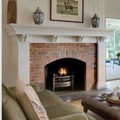 a living room filled with furniture and a fire place under a painting on the wall