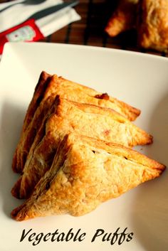 some food is on a white plate with the words vegetable puffs written below it