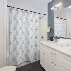 a bathroom with blue and white shower curtain