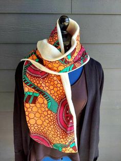 These are African prints neck warmers/ scarves are designed and backed with fleece to give it a warmer feel and to protect you from the cold during the winter.   They are so colorful they make you stand out and completes your look..It is beautiful,unique, mordern, ethnic soft and comfortable on the skin.. The African fabric is high quality wax print  100% Cotton. They can be a unique gift for the Christmas.. They can be given as birthday gifts..They can also be worn as accessories..The length is Warm Multicolor Winter Scarves, Handmade Winter Scarves As Gift, Casual One Size Scarves As A Gift, Casual Warm Multicolor Scarves, Warm Casual Multicolor Scarves, Casual One-size Scarf As Gift, Casual One-size Scarves Perfect For Gifts, Warm Multicolor Casual Scarves, Orange Shawl Scarves For Winter