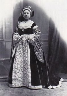 an old black and white photo of a woman wearing a dress with a large collar