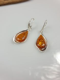 Welcome to my handmade shop. Item description: Sterling silver 925 earrings with Amber and all hallmarks. Length: 5 cm This item was made of natural Baltic Amber. All the amber used in my jewelry is collected in my home country Lithuania. I sell only genuine, real, not pressed, authentic, natural Baltic Amber. Item may have natural imperfections. Due to amber being natural, each of my jewelry is unique and even the same models can be slightly different. Please contact me for more details, photos Classic Amber Sterling Silver Earrings, Classic Pear-shaped Earrings For Gift, Anniversary Polished Dangle Earrings, Anniversary Dangle Earrings With Polished Finish, Polished Drop Earrings For Gift, Classic Oval Teardrop Earrings For Gift, Classic Oval Teardrop Earrings As Gift, Polished Finish Drop Earrings For Gift, Classic Teardrop Hallmarked Earrings