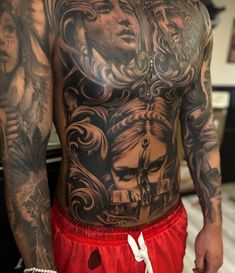 a man with many tattoos on his back