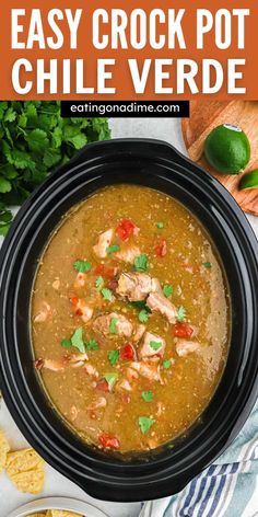 a crock pot filled with chicken and tortilla soup, garnished with cilantro