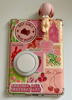 a toy doll is sitting on top of a mother's day card holder with magnets