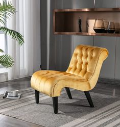 a yellow chair sitting on top of a rug in front of a wooden shelf filled with vases