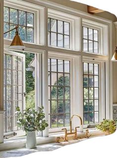 an open kitchen window with potted plants on the counter