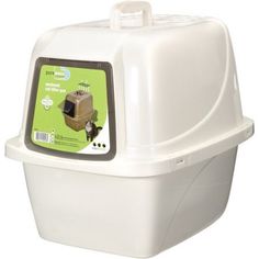 a white plastic litter box with a green label on the lid and an animal inside