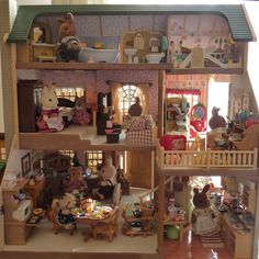 a doll house with all the furniture and accessories in it's rooms, including two floors