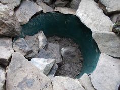 there is a hole in the rocks that looks like it's going to be filled with water