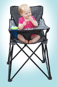 a baby sitting in a high chair eating food