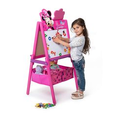 Sure to inspire the sweetest sketches, this Disney Minnie Mouse Double-Sided Activity Easel with Storage from Delta Children is designed with a magnetic, dry-erase surface on one side and a chalkboard on the other. Featuring a cute silhouette of Minnie on top, it includes a magnetic character puzzle, alphabet magnets and two fabric bins underneath, so your child can store chalk, markers and all their works of art.  Product Features:  * Ages 3-8 * Includes a chalkboard side and a magnetic dry-erase side * Constructed from strong and sturdy wood and fabric bins * Meets or exceeds all safety standards set by the CPSC * Includes easel, 2 fabric bins, puzzle and alphabet magnets * Warranty: 90 days limited parts  (Model TE87574MN-1058) Product information is provided by the supplier and BJ’s do Decorative Magnetic Board, Wooden Drawing Board, Minnie Mouse Bedroom, Kids Easel, Alphabet Magnets, Wooden Easel, Disney Gift, Delta Children, Gift Giver