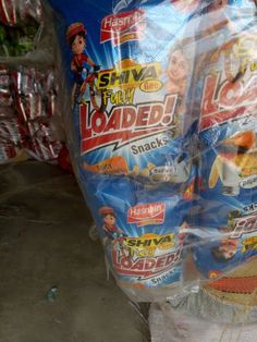 a bag of loaded snacks sitting on top of a pile of plastic wrap next to other bags