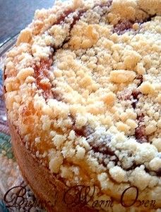 a cake sitting on top of a glass plate covered in crumbled toppings