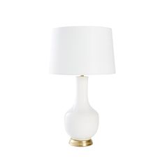 a white table lamp with a gold base