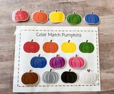 the color match pumpkins game is shown on a wooden table with paper cut outs