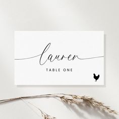 a place card with a black bird on it